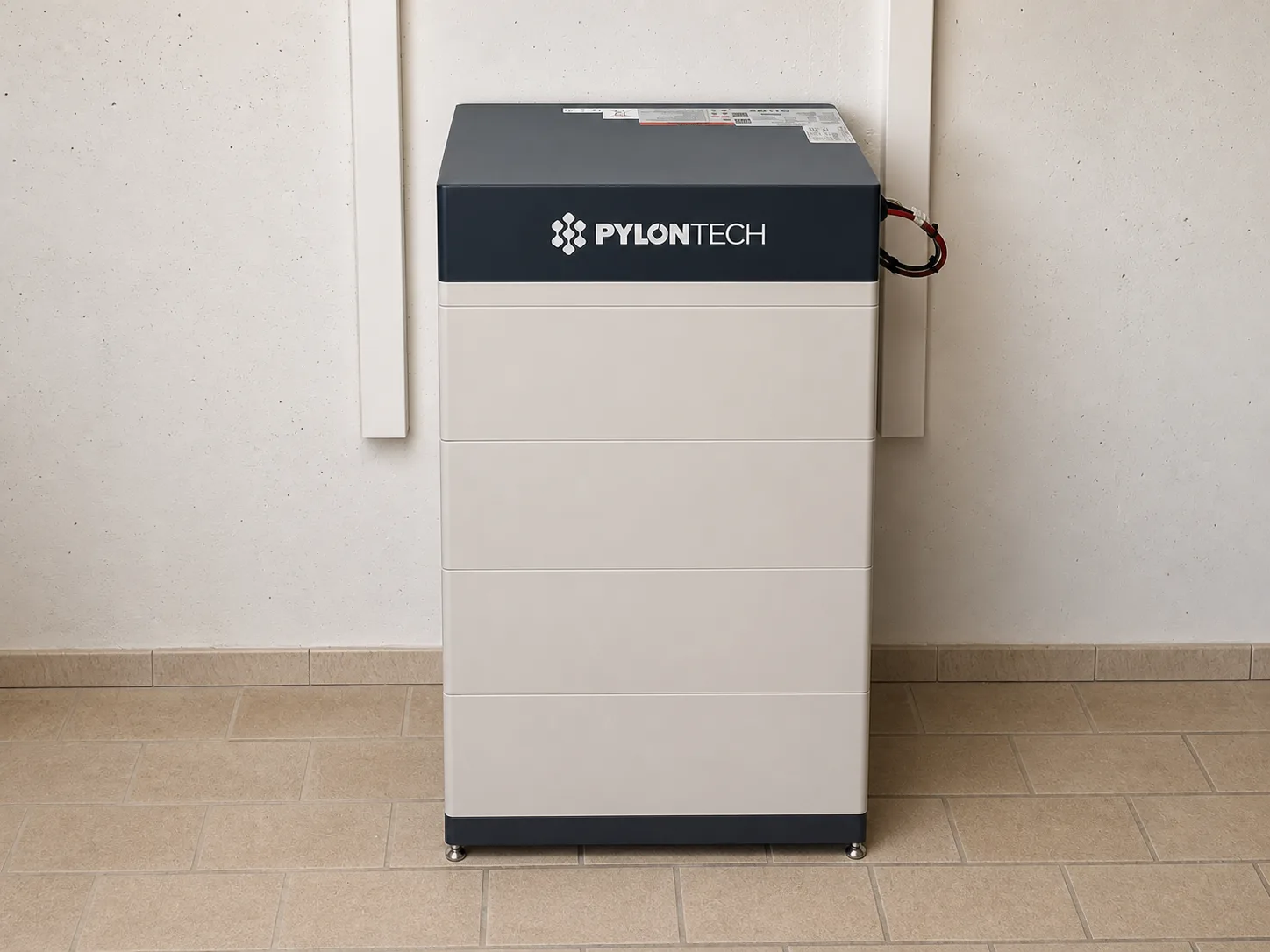 Freistehender Pylontech Stromspeicher in einem Raum mit Fliesenboden.